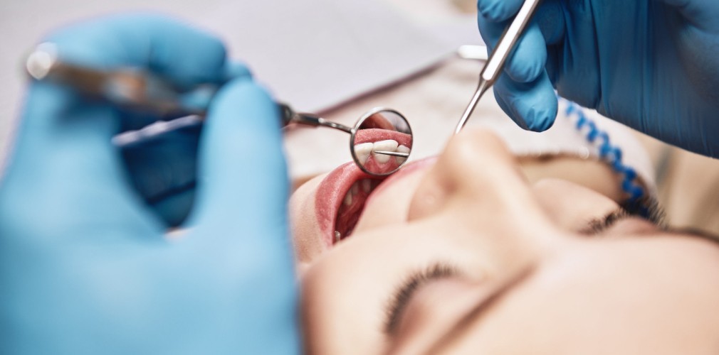 Examen des gencives au miroir et à la sonde chez une patiente